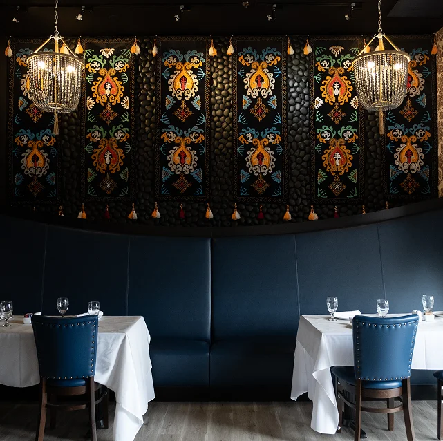 Elegant restaurant interior with colorful wall art and stylish seating