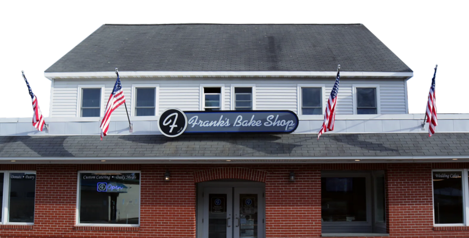 Charming bakery exterior with American flags and inviting entrance
