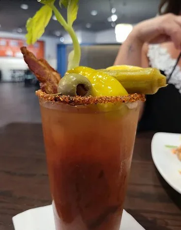 Classic Bloody Mary cocktail garnished with celery and olives