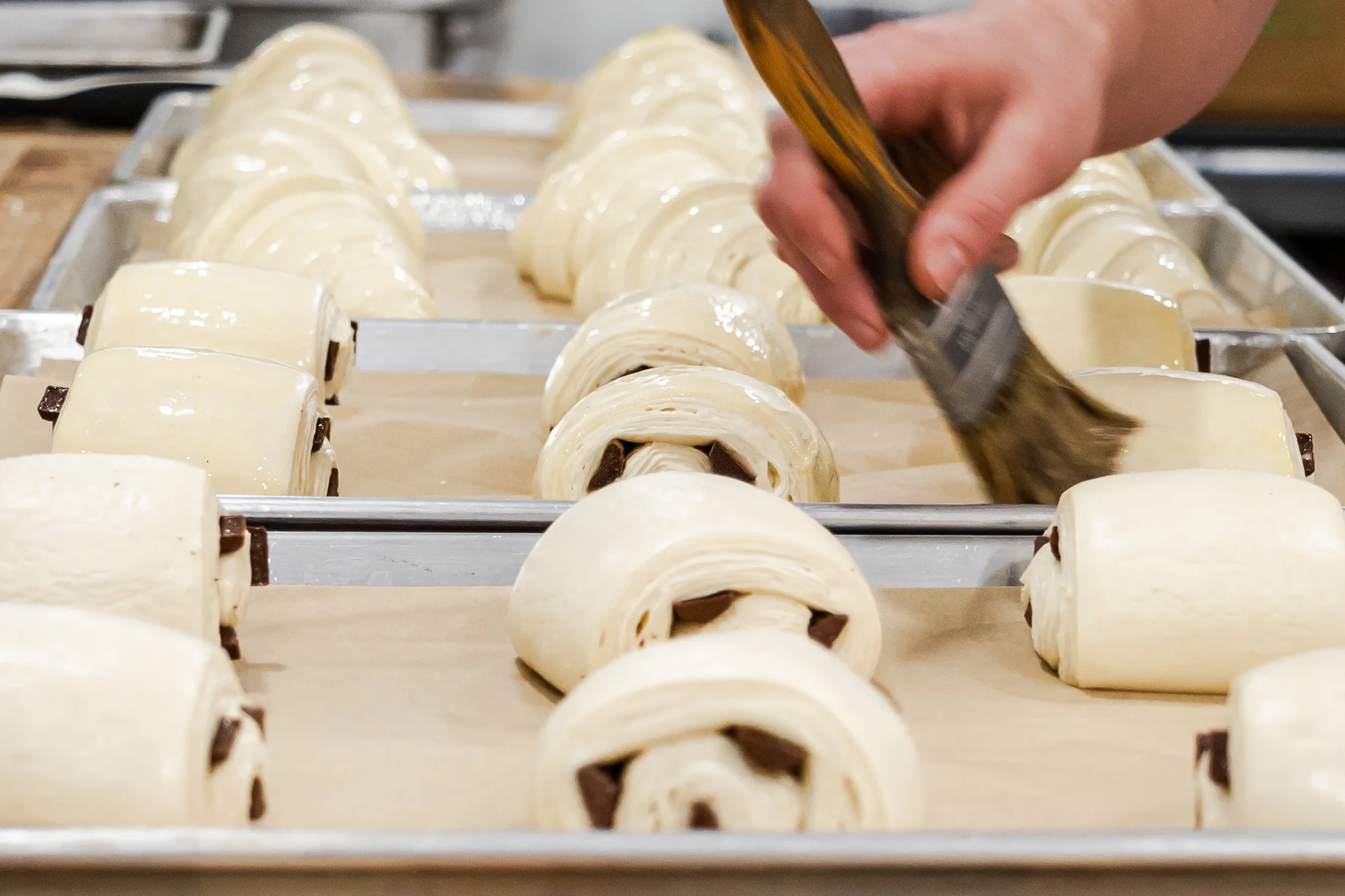 Freshly baked chocolate croissants on a baking tray