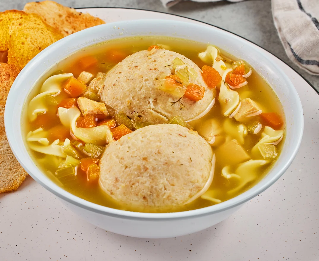 Chicken matzoh ball soup with noodles and vegetables