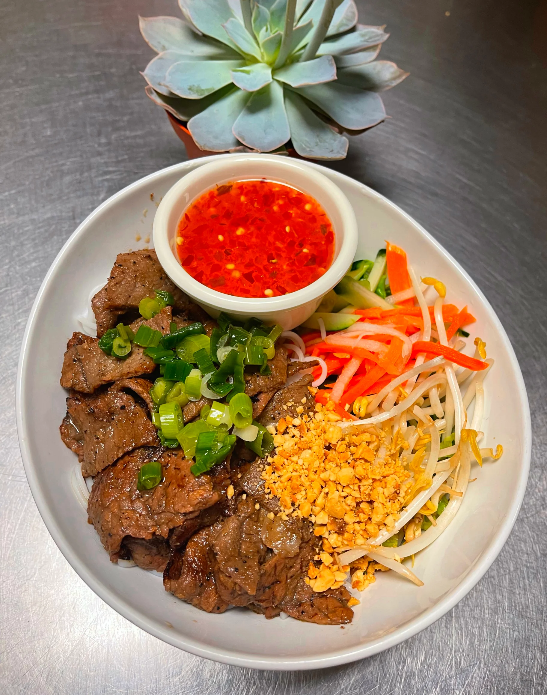 Vietnamese bun bo xao with grilled beef and fresh vegetables