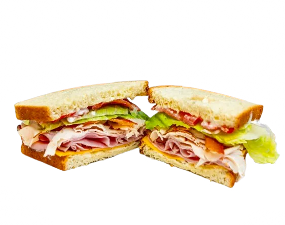 A delicious sandwich with layers of meats, lettuce, and tomato on bread.