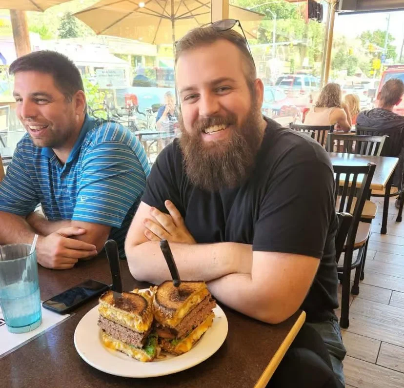 Giant cheeseburger stack in a casual dining setting