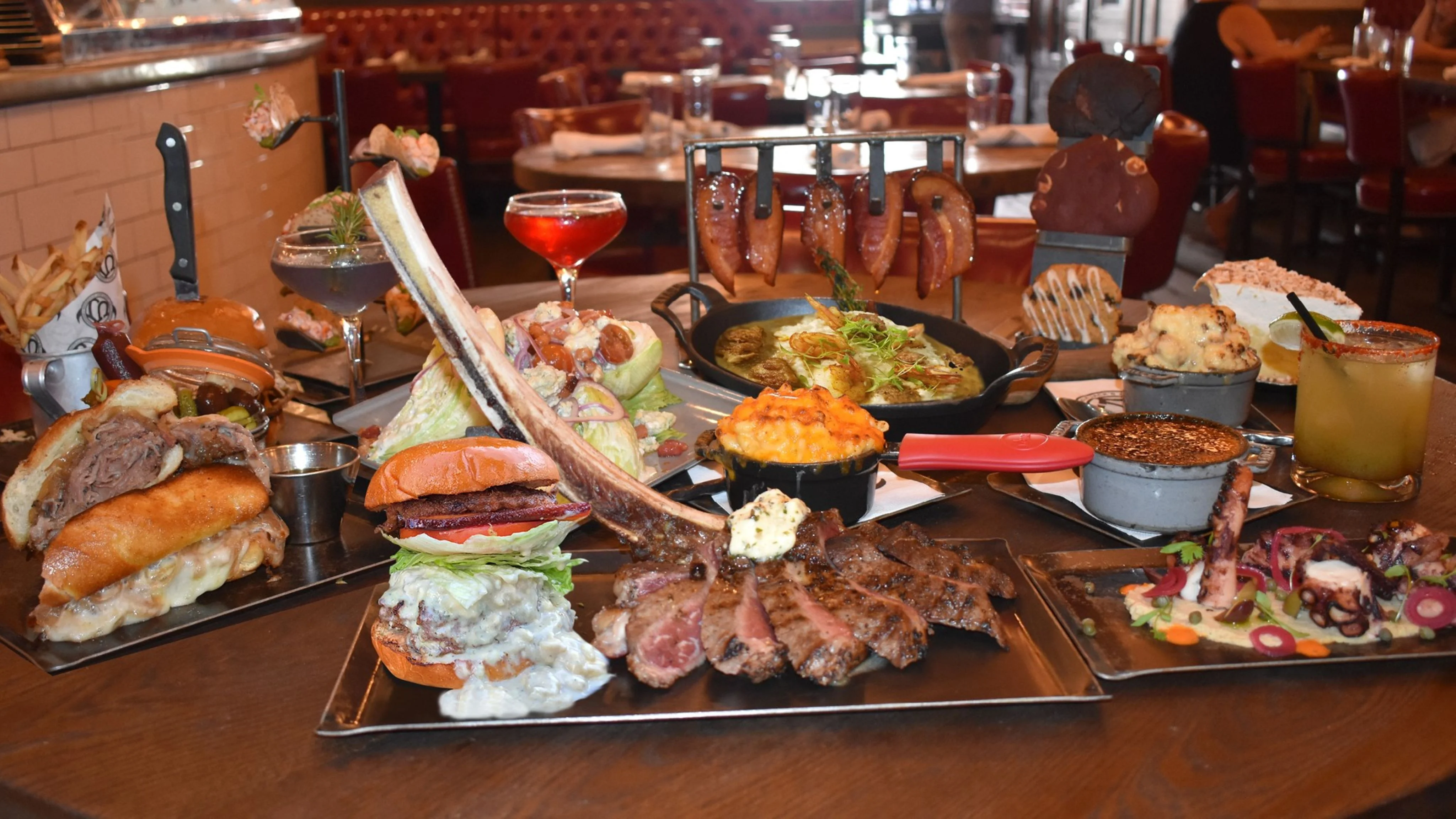 Restaurant spread of burgers, grilled steaks, ribs, seafood, and cocktails