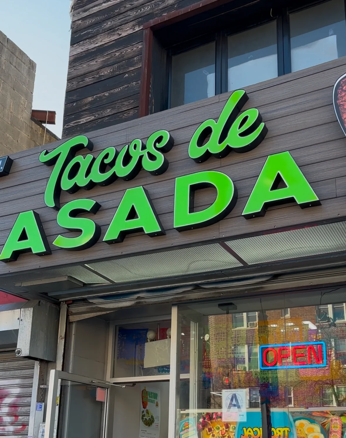 Tacos de asada sign at a vibrant Mexican restaurant