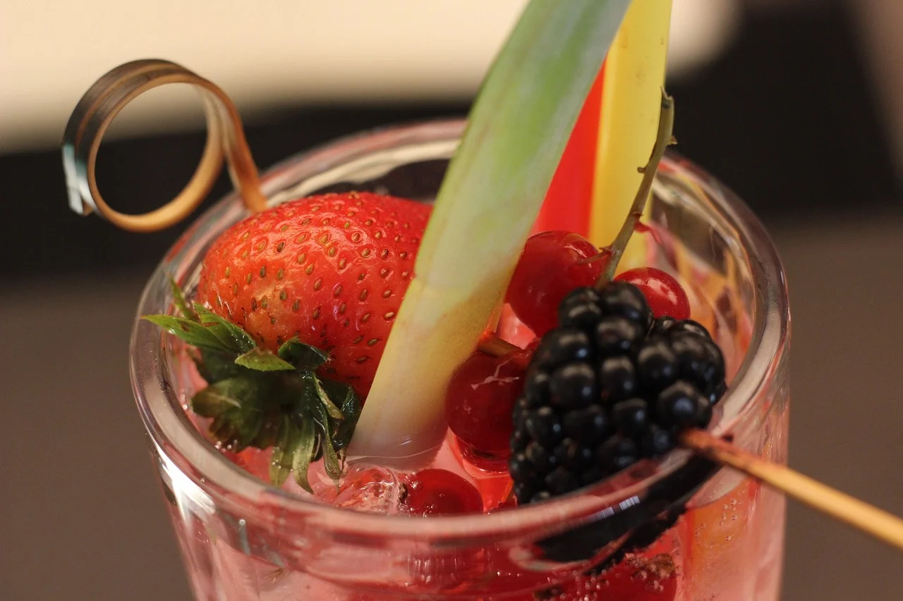 Colorful fruit cocktail garnished with berries and citrus