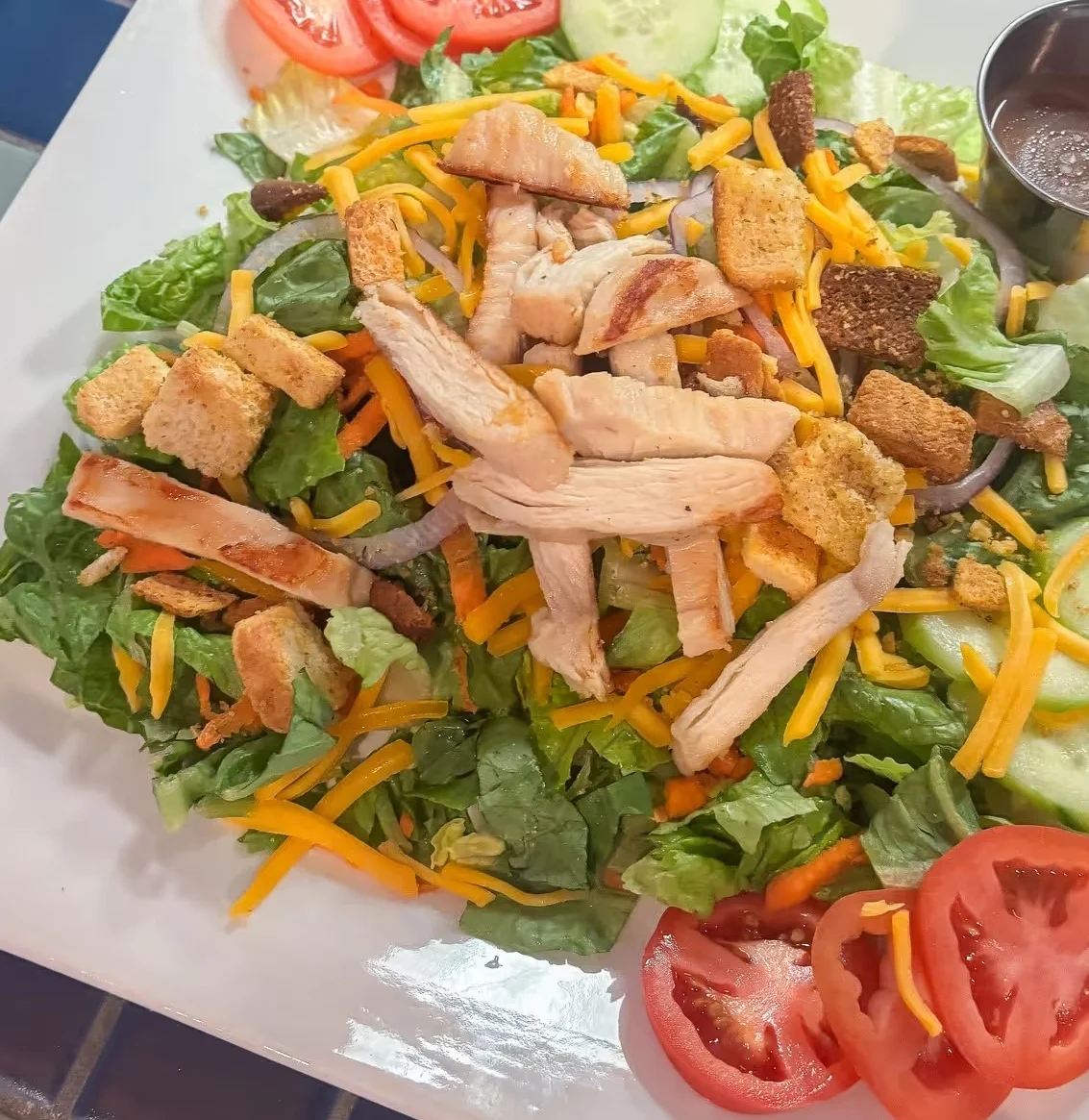 Delicious gourmet burger with fresh toppings on a wooden table