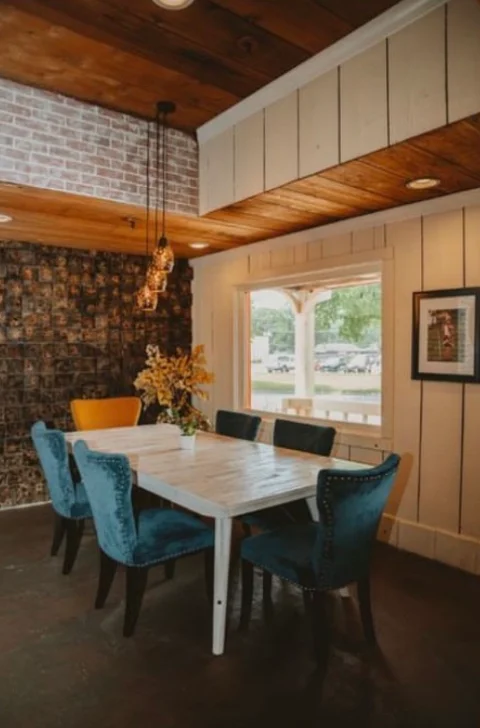 Cozy restaurant dining area with blue chairs and rustic decor