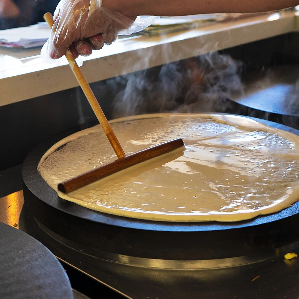 Making dosa on a hot griddle in an Indian kitchen