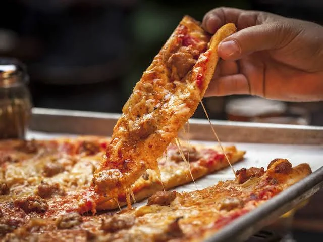 Cheesy sausage pizza slice with gooey mozzarella