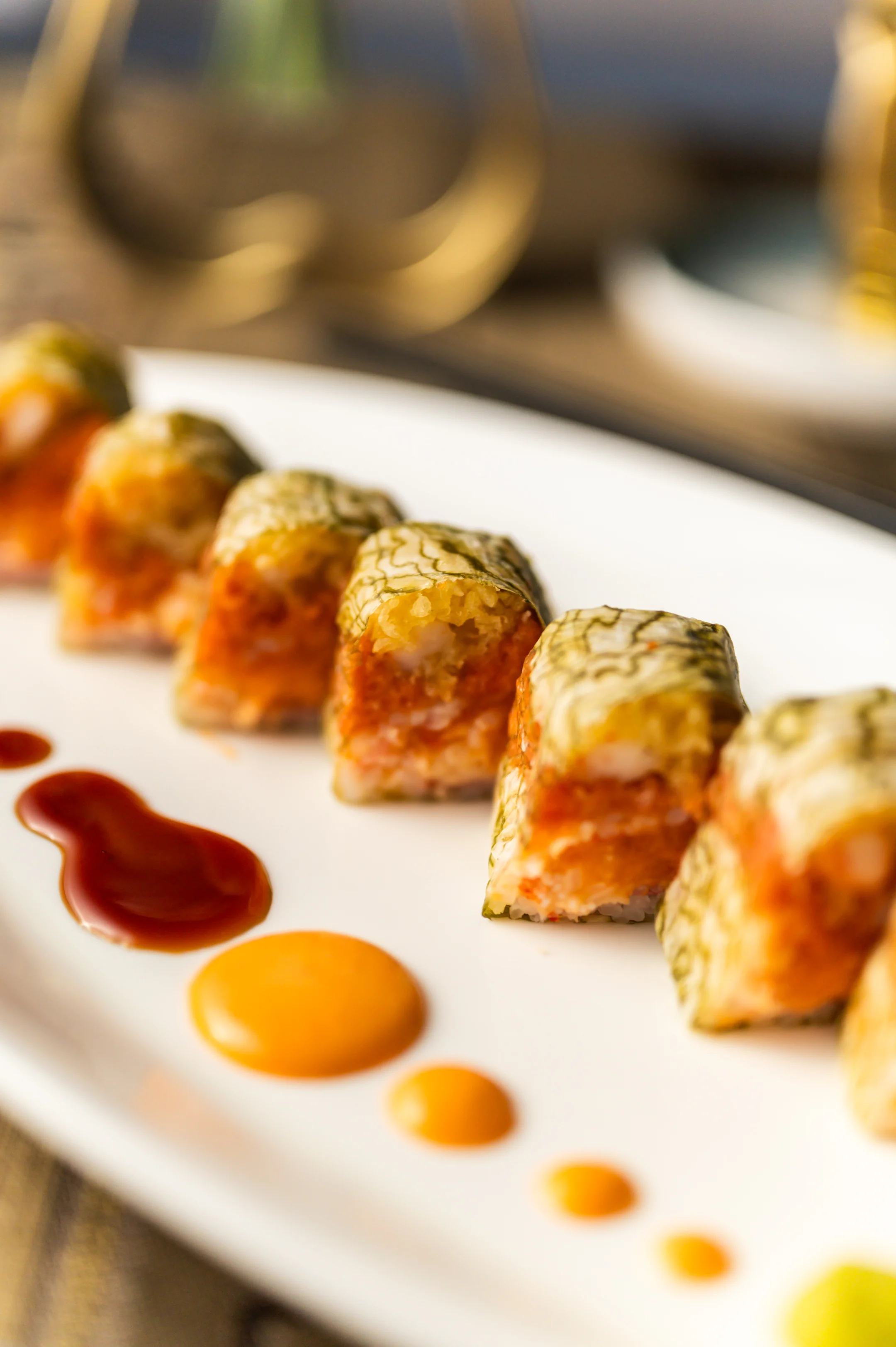 Japanese sushi rolls with vibrant sauces