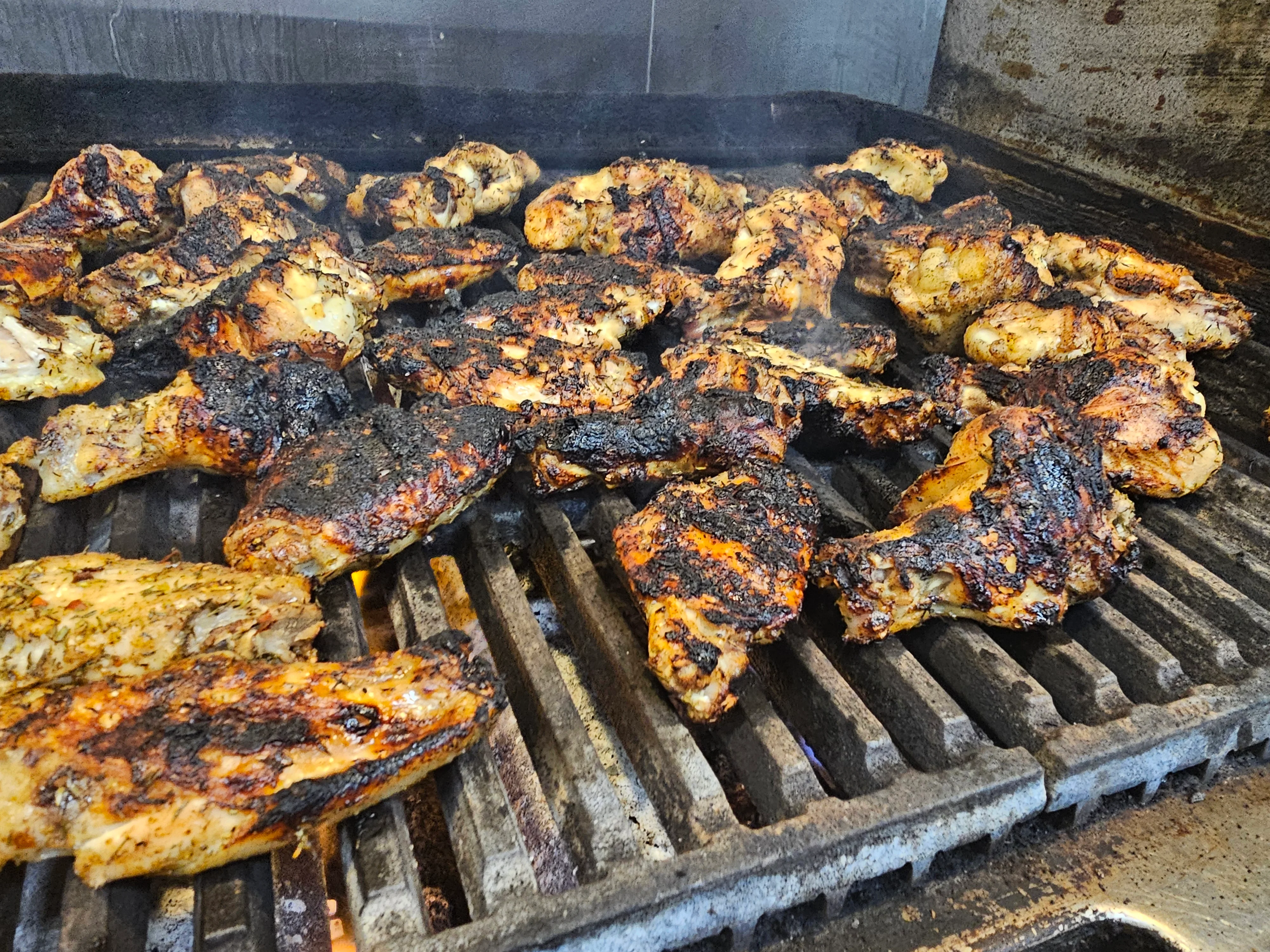 Grilled Jamaican jerk chicken on a barbecue grill