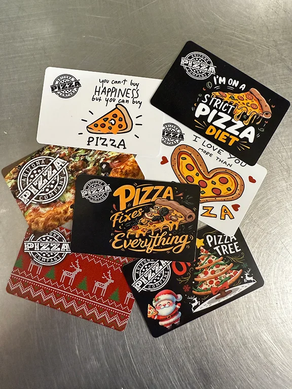 Colorful pizza-themed gift cards with fun slogans