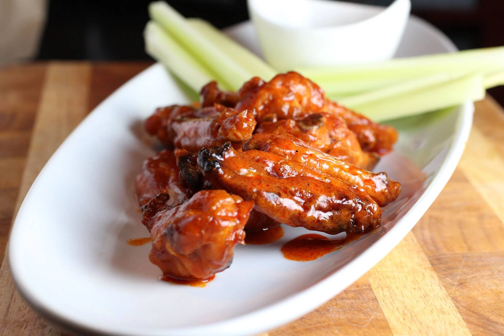 Buffalo chicken wings with celery sticks and dipping sauce
