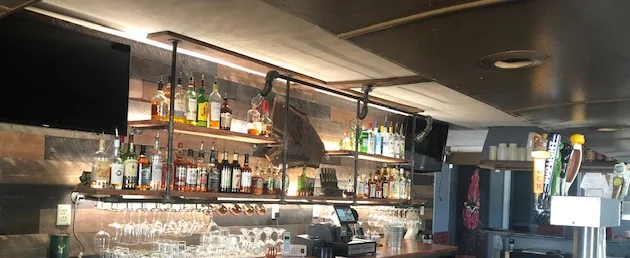 Stylish bar counter with a variety of spirits and glassware