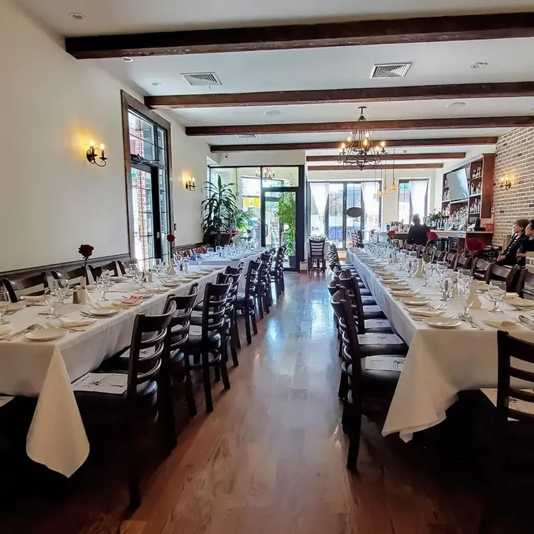 Elegant restaurant interior with long dining tables and warm lighting