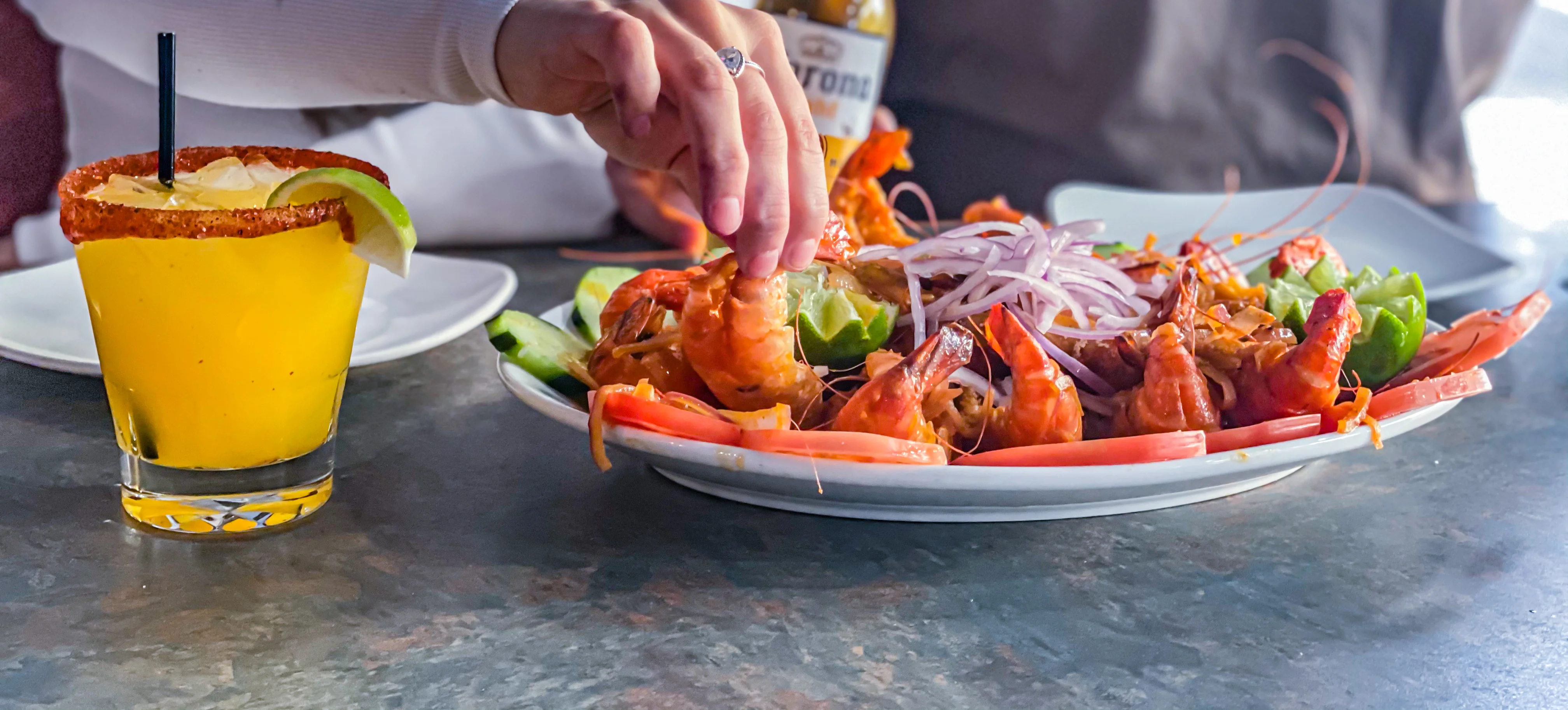 Seafood platter with shrimp and lime in a vibrant restaurant setting