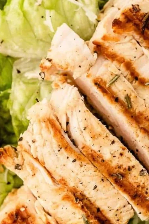 Grilled chicken Caesar salad with croutons and romaine lettuce