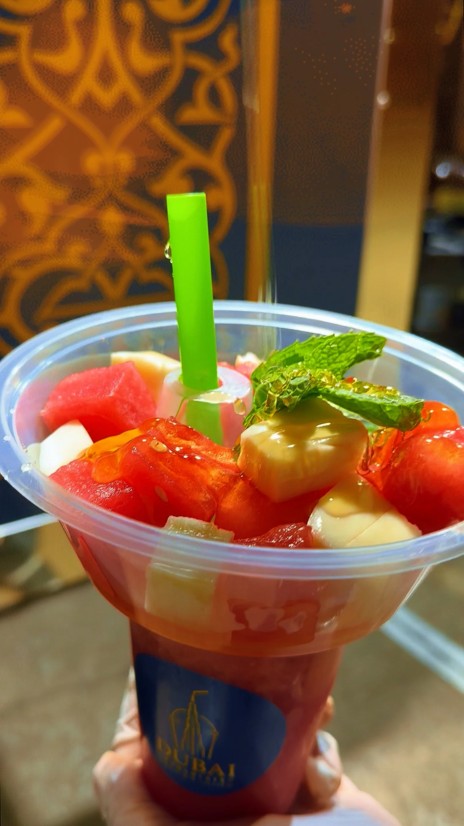 Refreshing fruit salad in a cup with mint garnish
