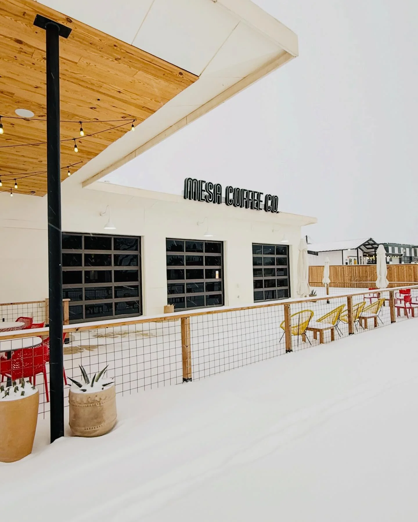 Modern coffee shop exterior in snowy landscape