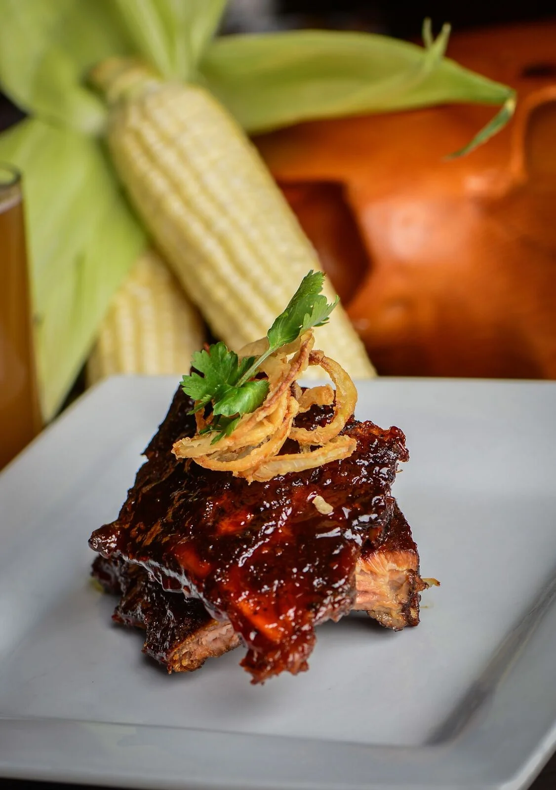 BBQ ribs glazed with sauce, garnished with crispy onions