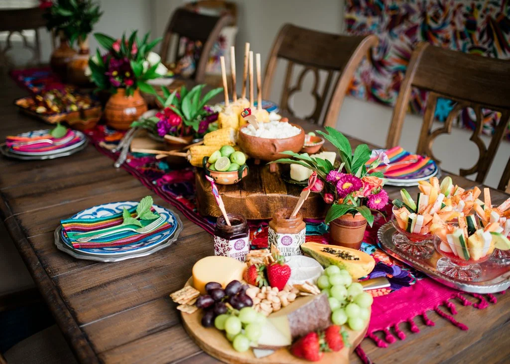 Colorful Mexican fiesta spread with various traditional dishes and decorations.