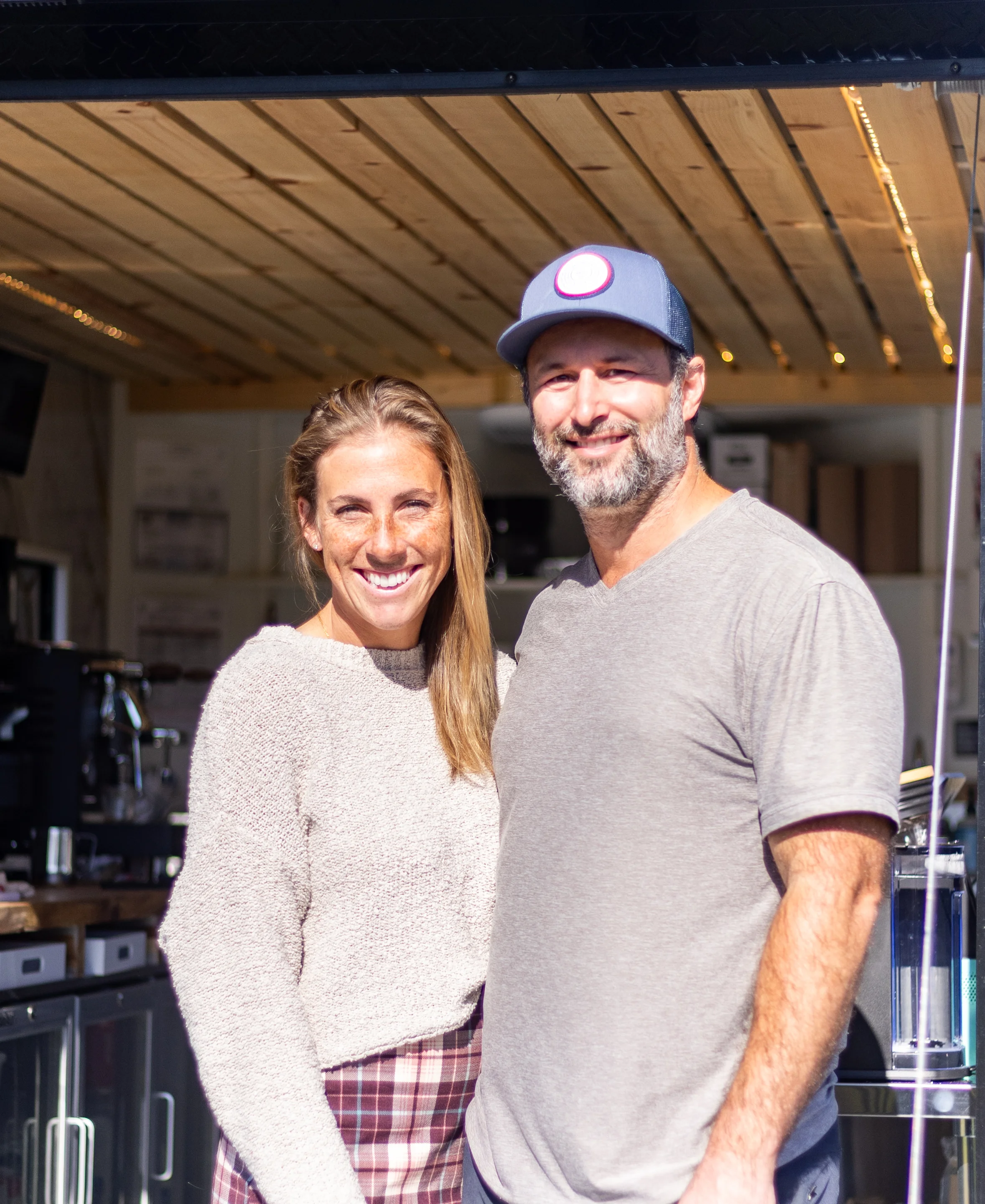 Smiling couple in front of a cozy café