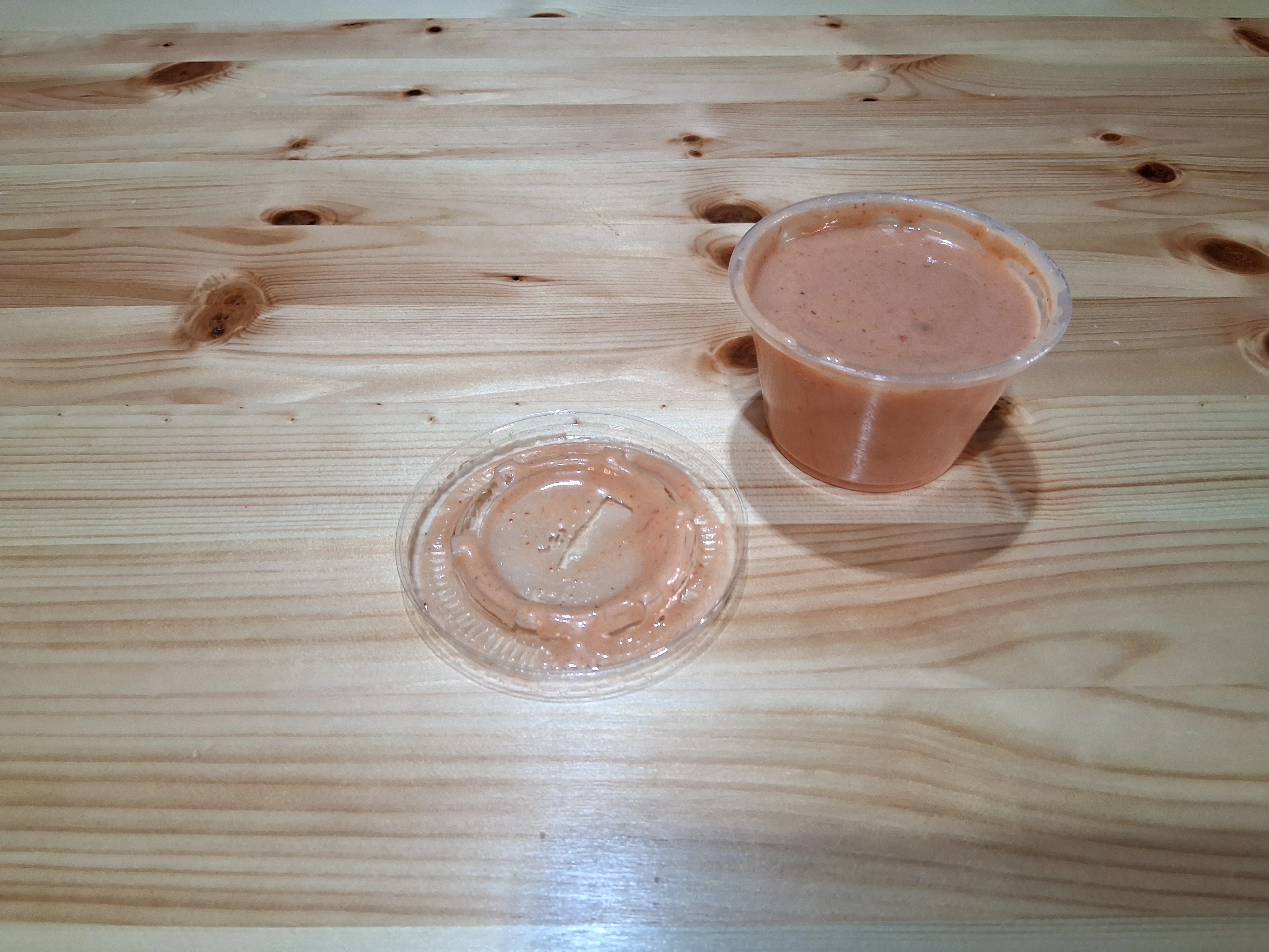Creamy chipotle sauce in a plastic cup