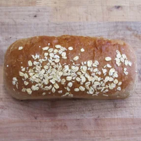 Freshly baked oat-topped bread loaf