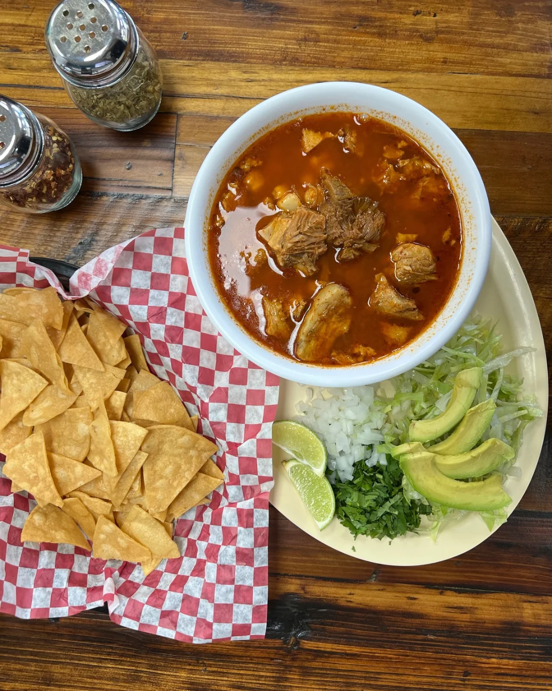 Hearty Mexican pozole served with tortilla chips and fresh toppings