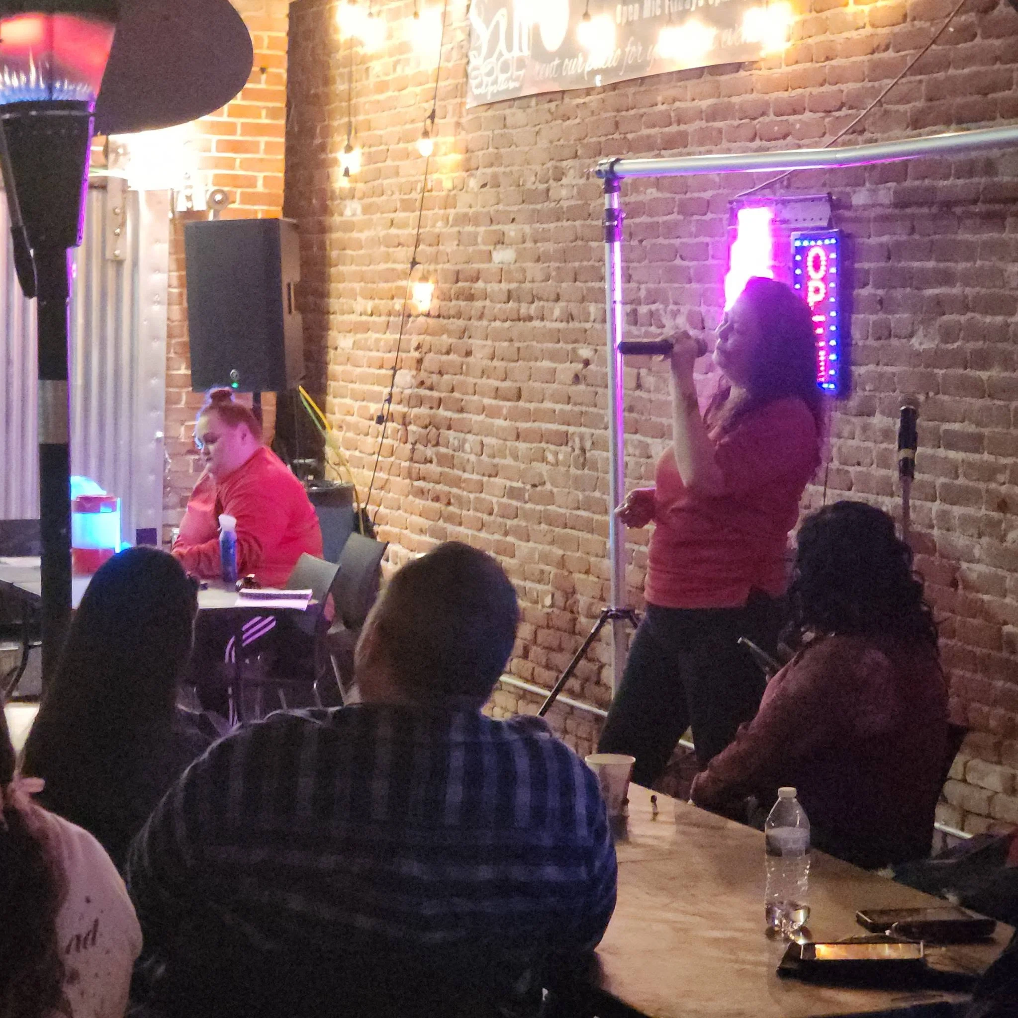 Live performance in a cozy restaurant with exposed brick and warm lighting