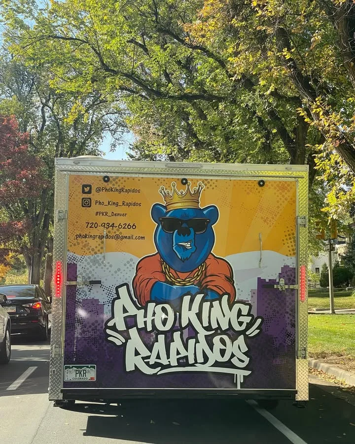 Colorful food truck featuring Vietnamese pho branding