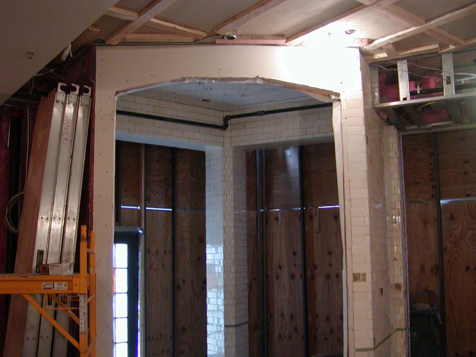 Under-construction restaurant interior with exposed walls and scaffolding