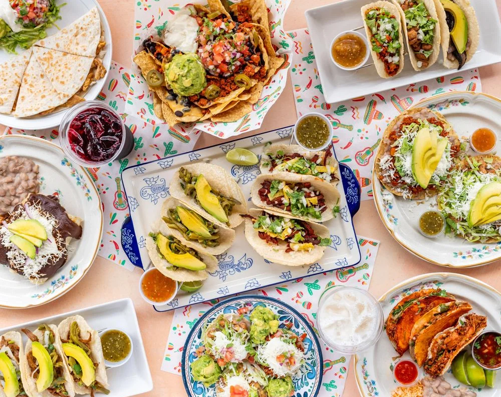 Colorful spread of Mexican tacos and nachos with guacamole