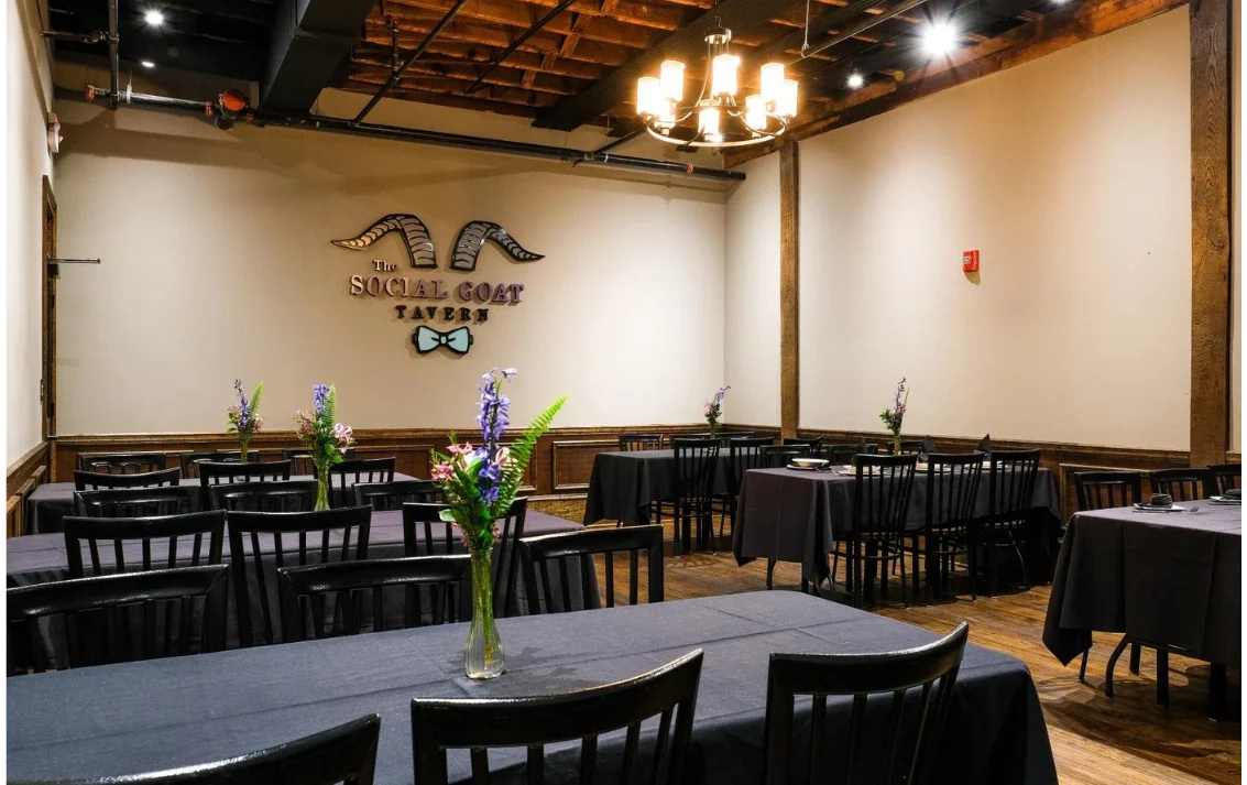 Elegant restaurant interior with dark tables and warm lighting