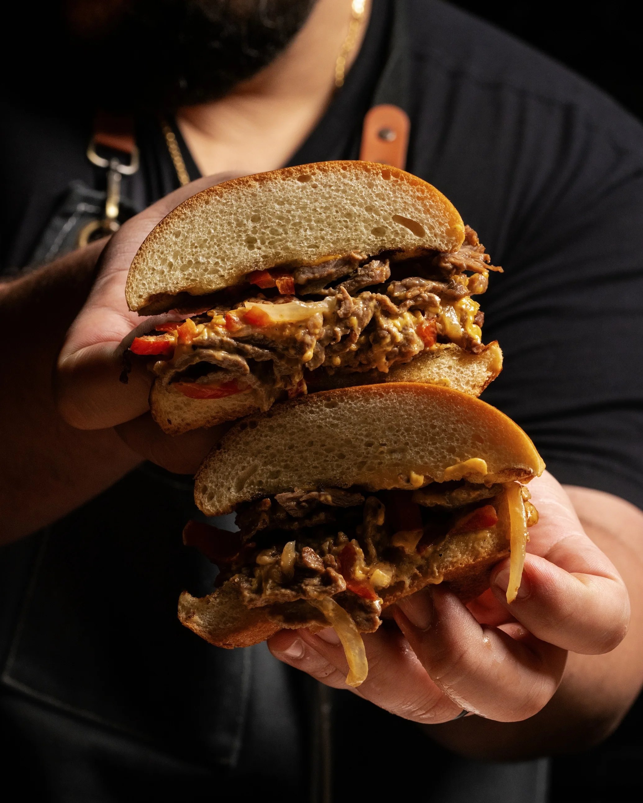 Loaded cheesesteak sandwich with peppers and onions