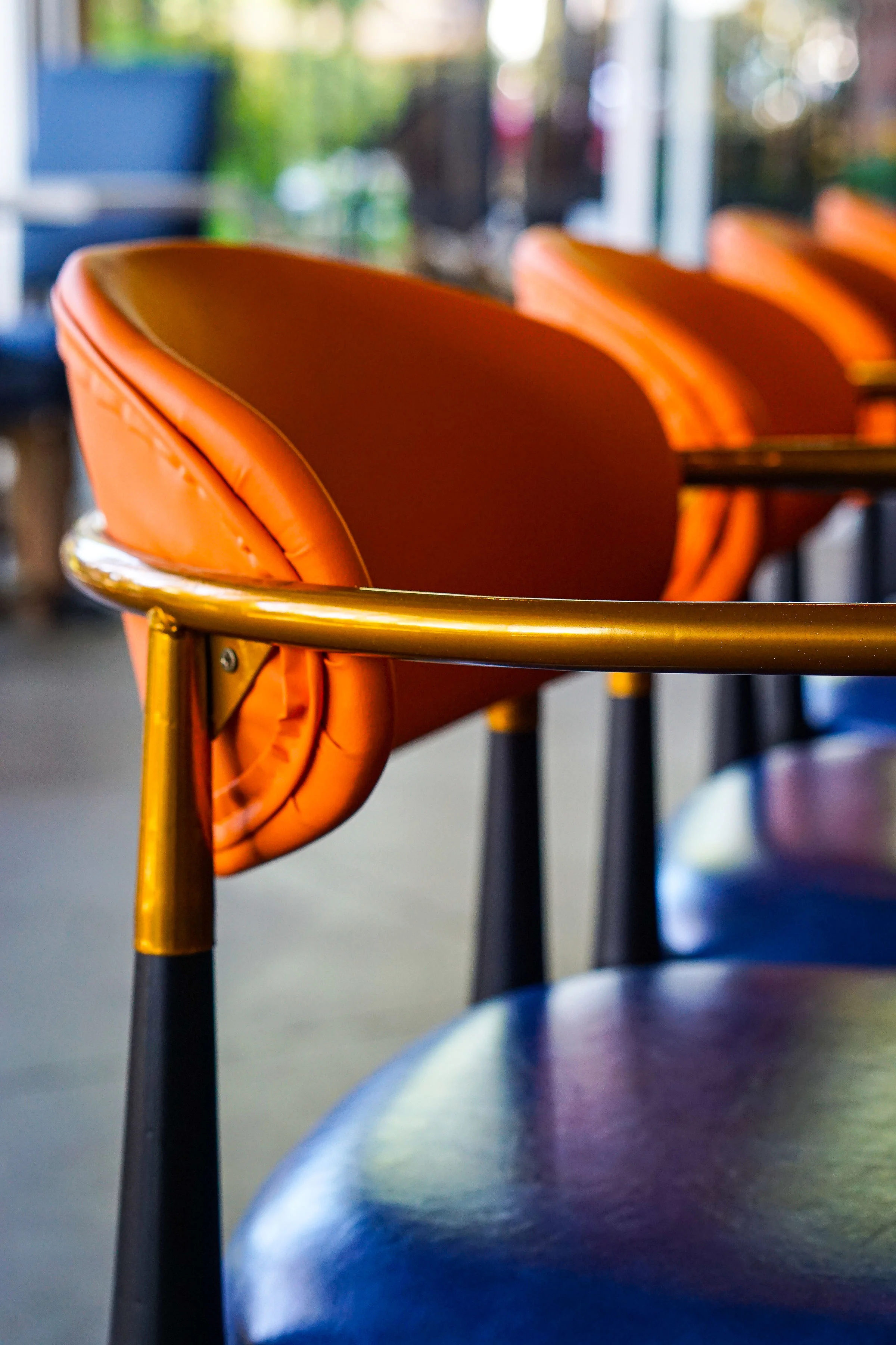 Stylish orange and gold restaurant chairs in a modern setting