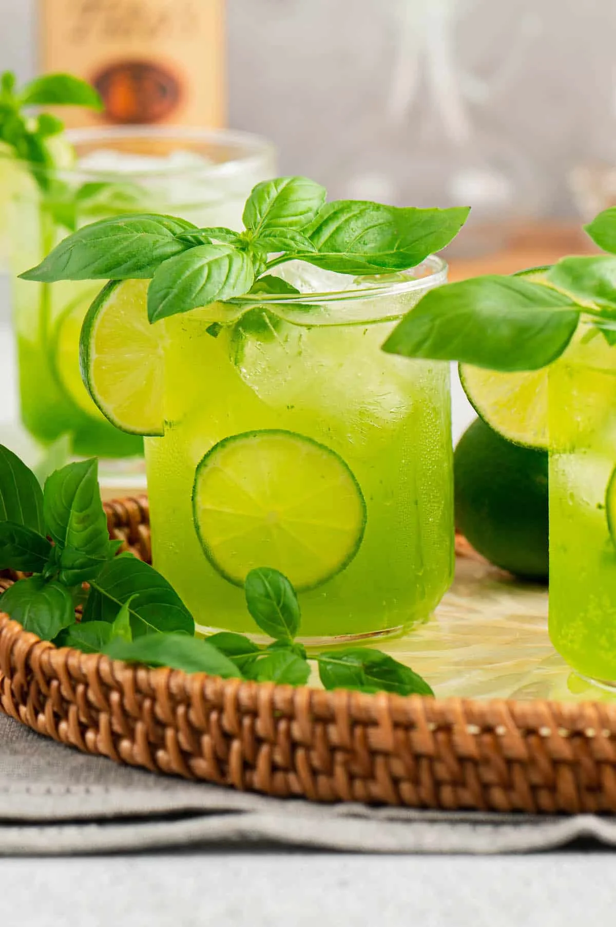 Refreshing basil lime cocktail in glasses with ice