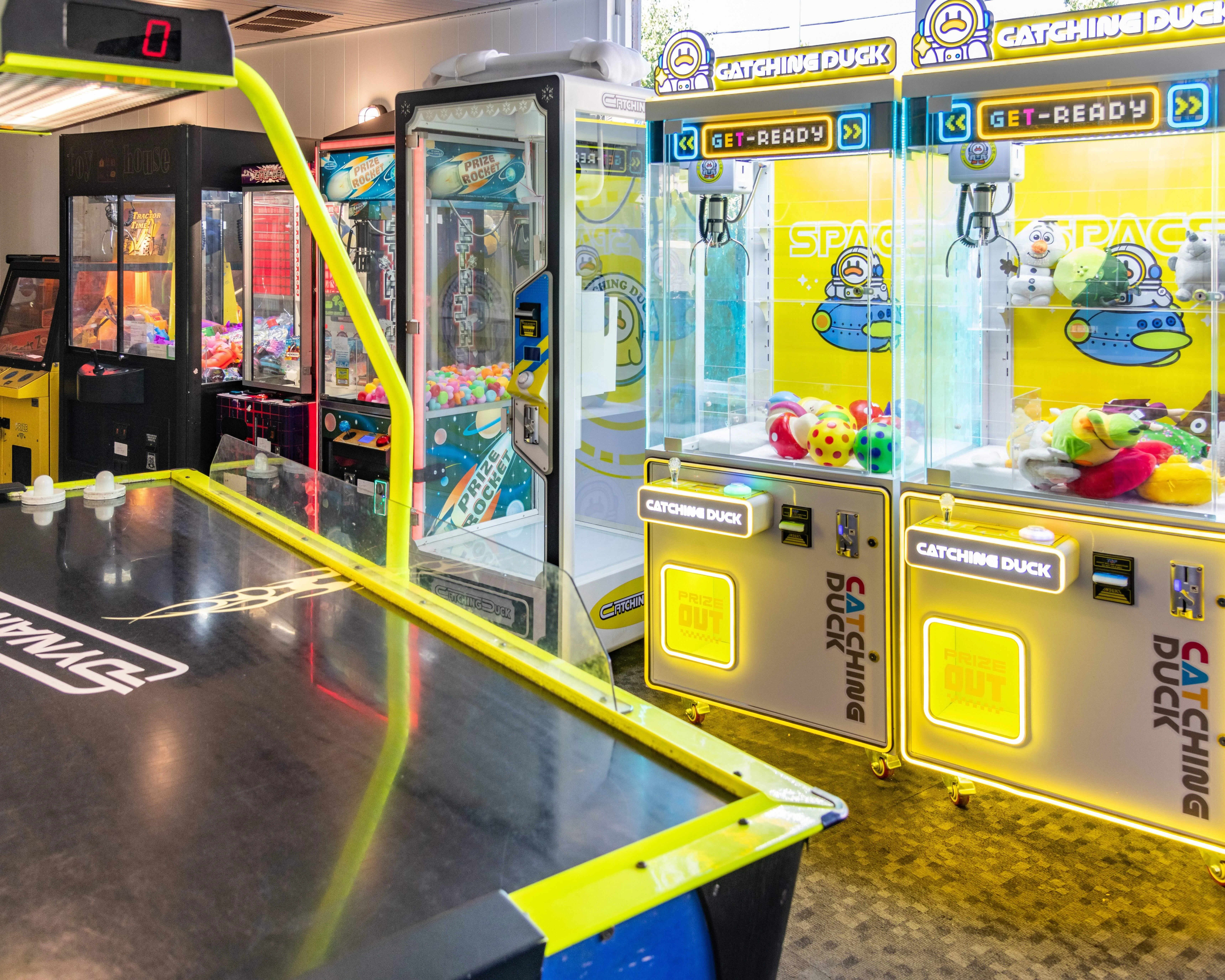 Colorful arcade games and air hockey table in a fun entertainment center