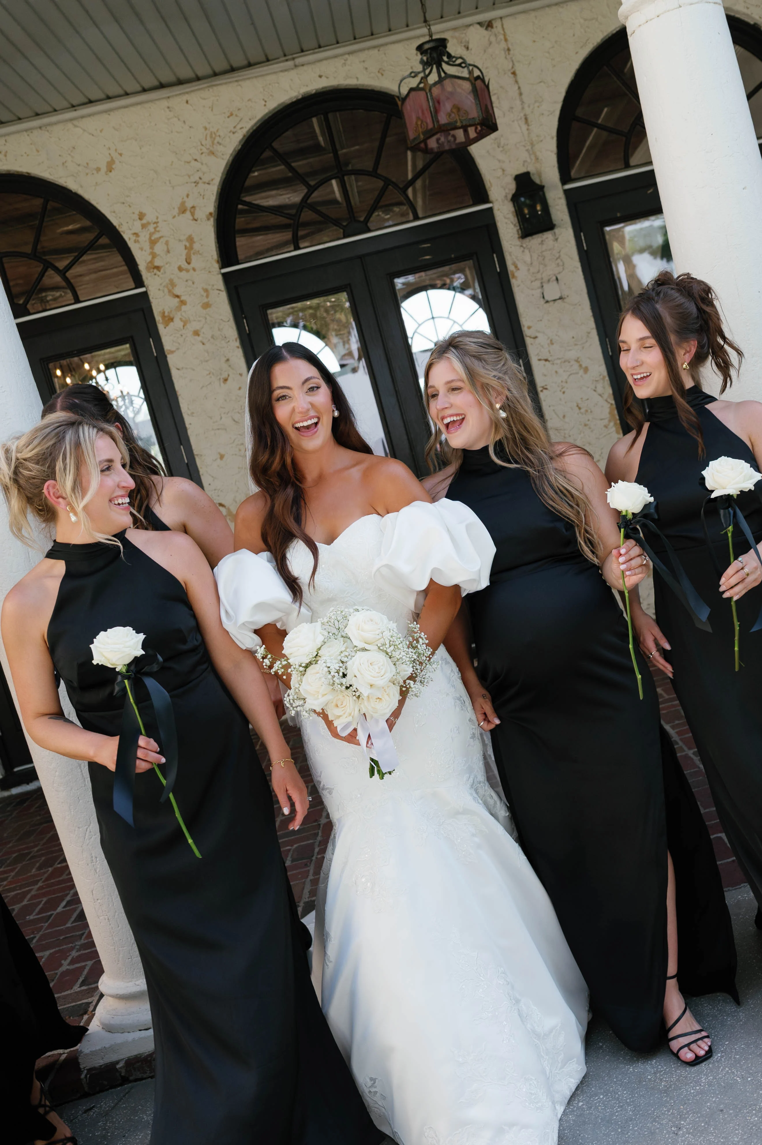 Bridal party celebrating with laughter and flowers