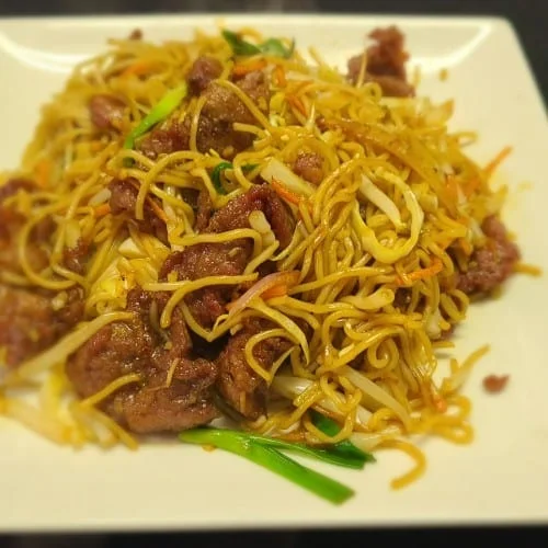 Vegetable Mandarin Noodles served in a bowl with colorful vegetables.