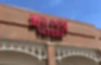 Restaurant exterior with bold signage against a blue sky