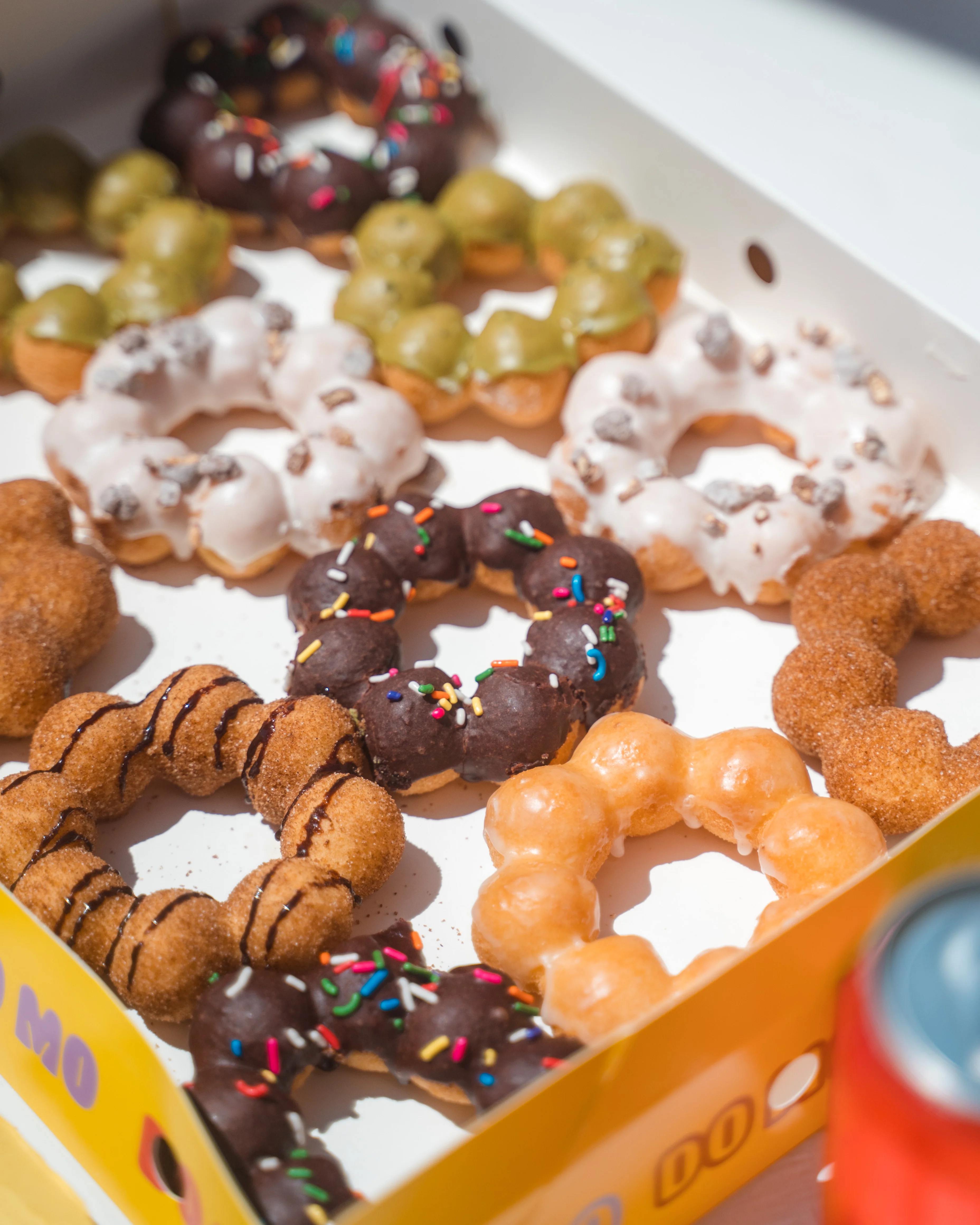 Colorful assortment of gourmet donuts in a box