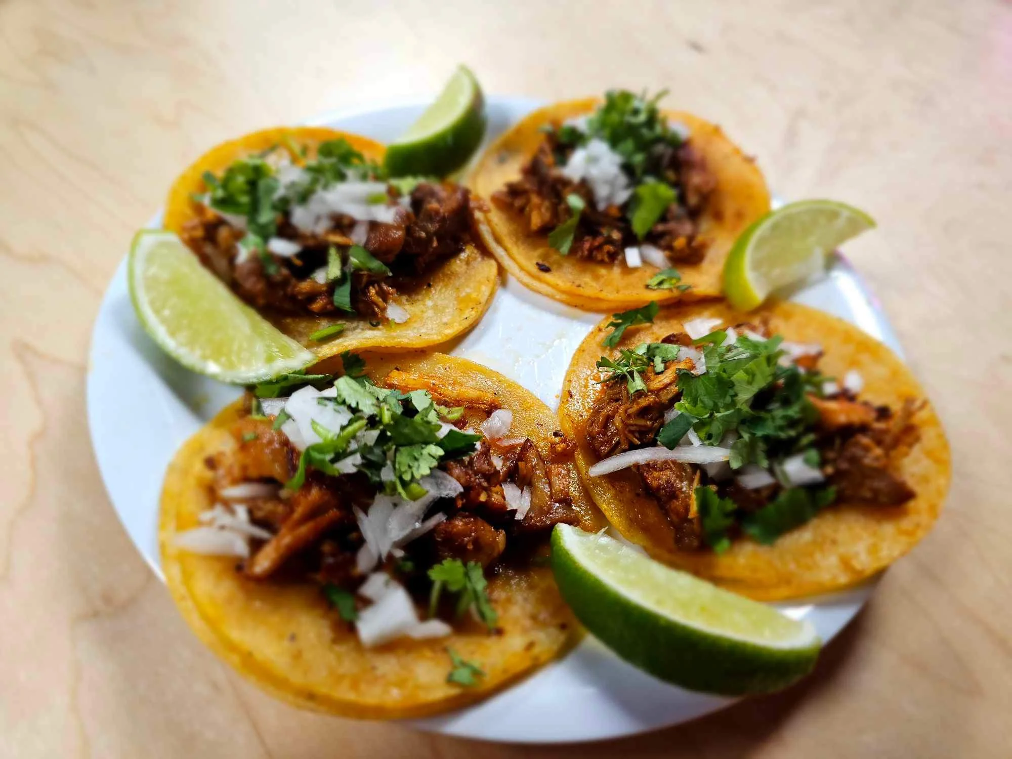 Authentic Mexican tacos al pastor served with lime and fresh toppings