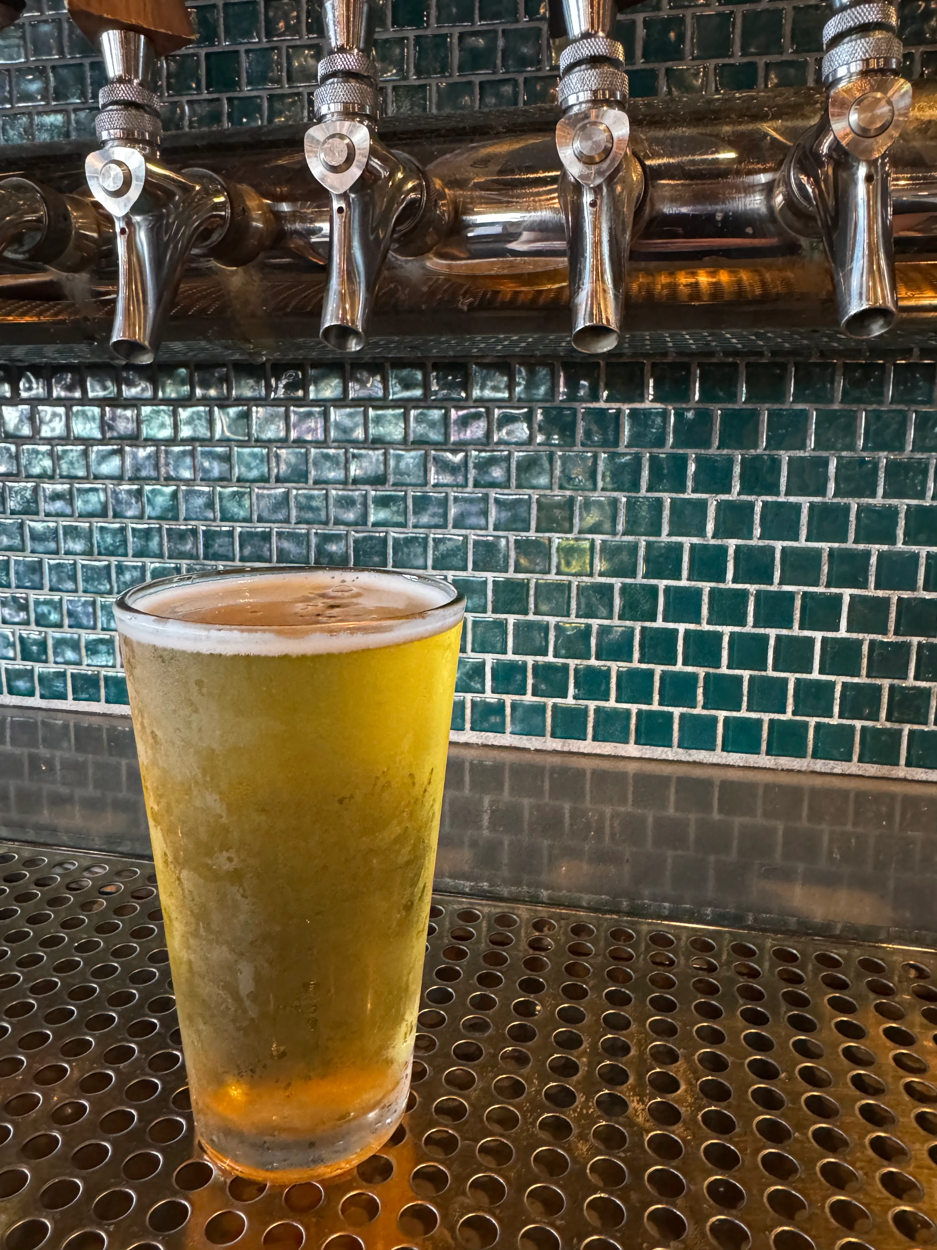 Chilled glass of craft beer at a bar counter