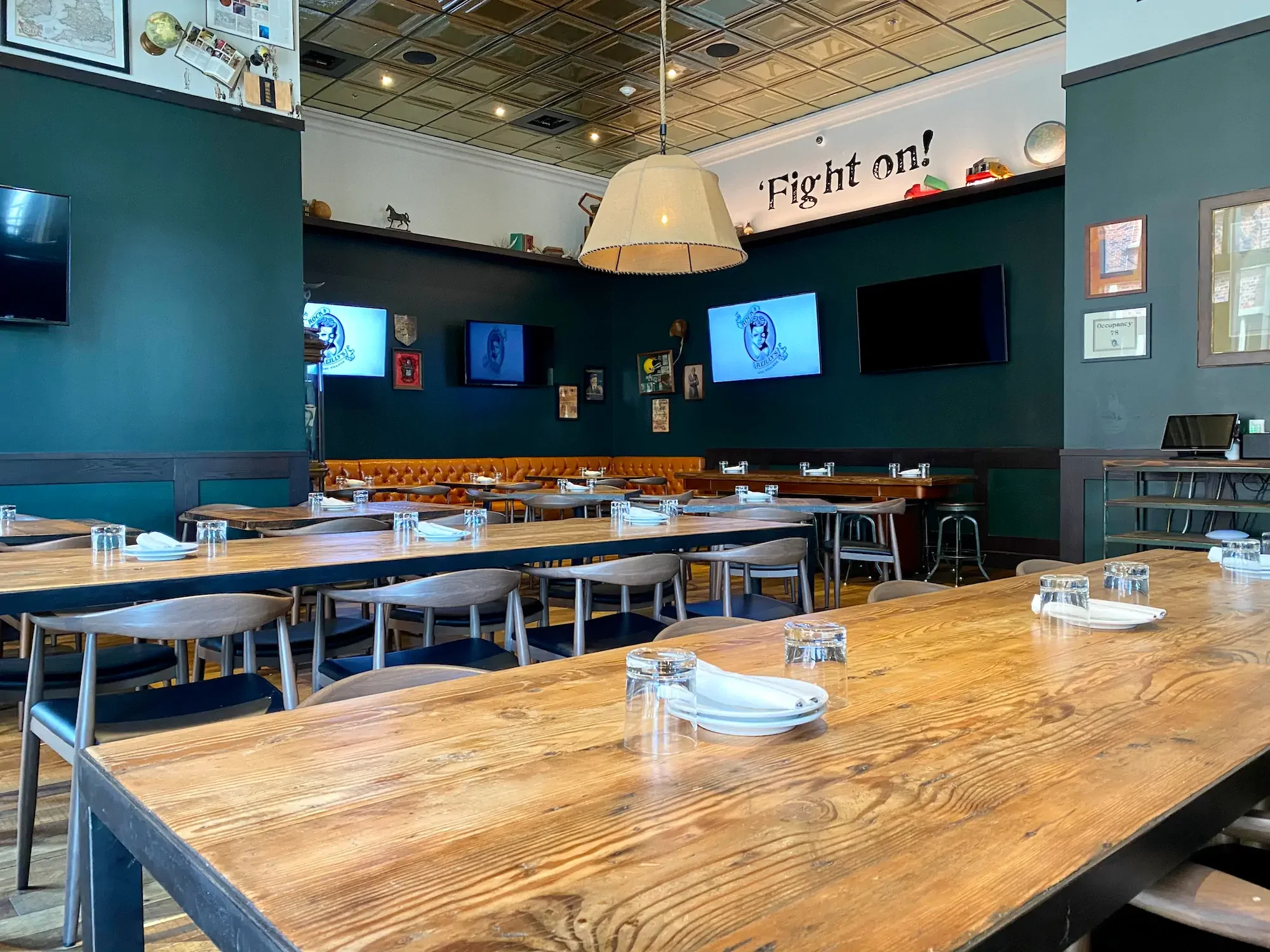 Stylish restaurant interior with wooden tables and green walls