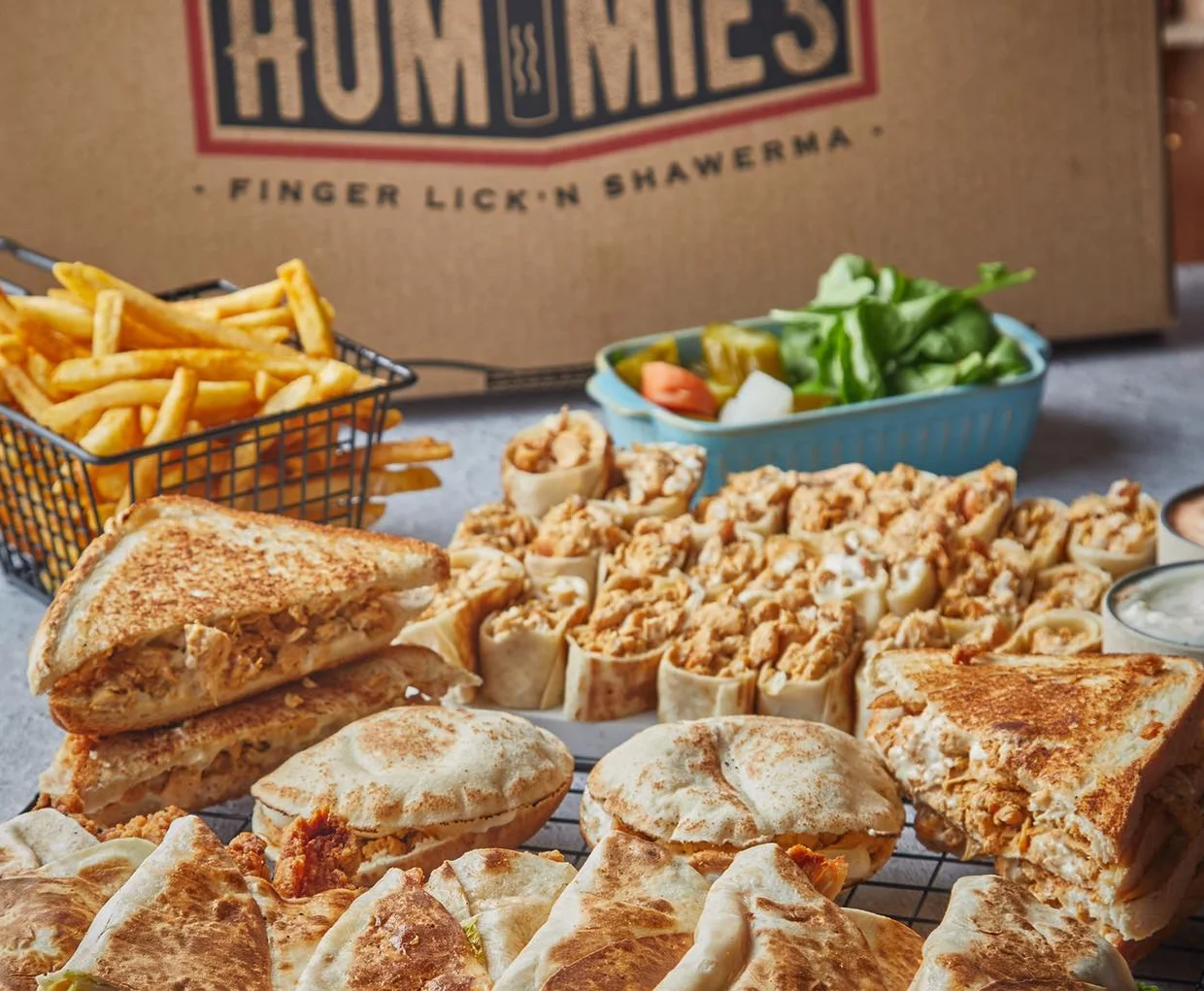 Assorted shawarma wraps and fries from a Middle Eastern restaurant