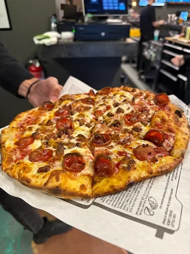 Pepperoni and sausage pizza served hot from the oven