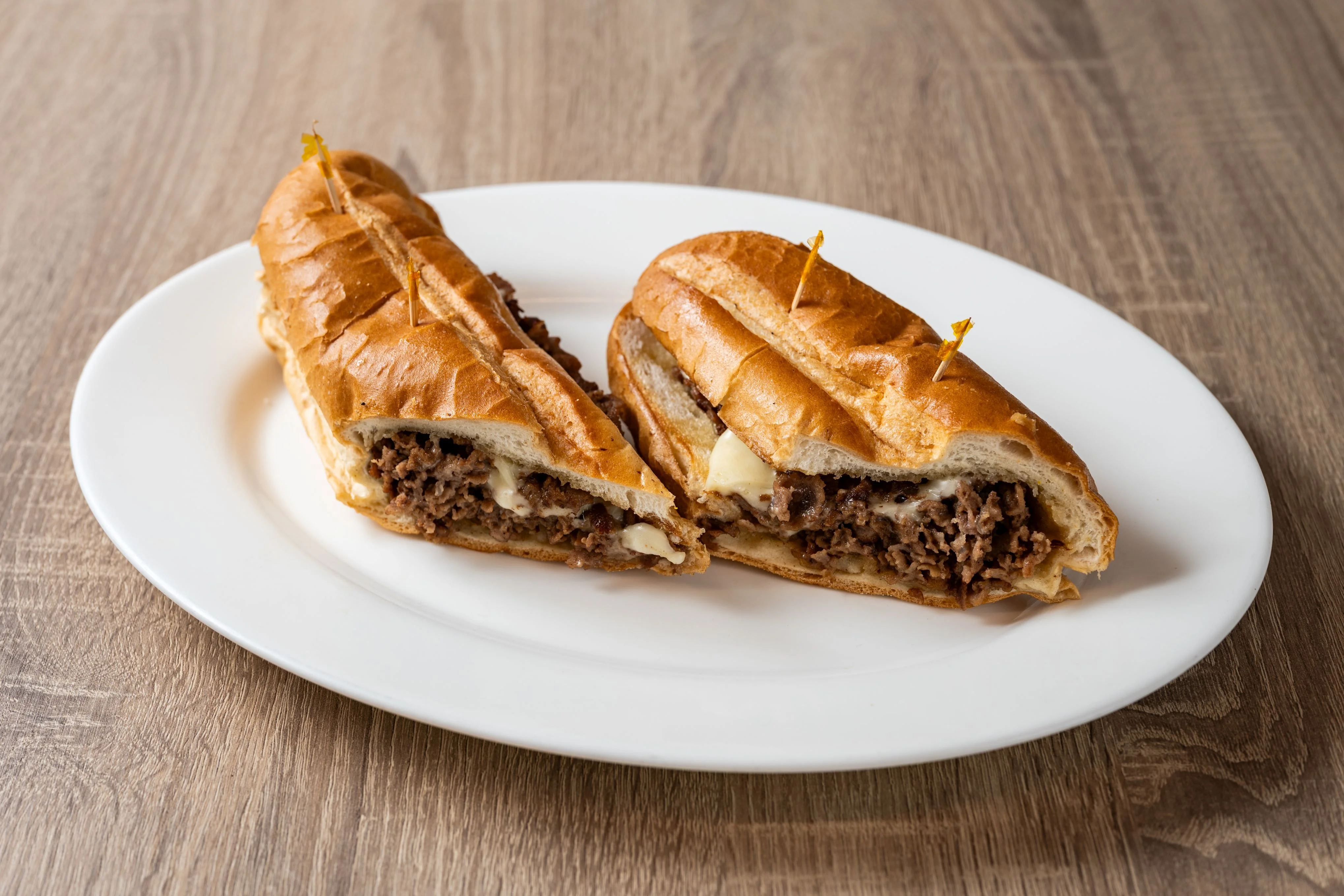 Delicious deli sandwich with fresh ingredients on a wooden table.